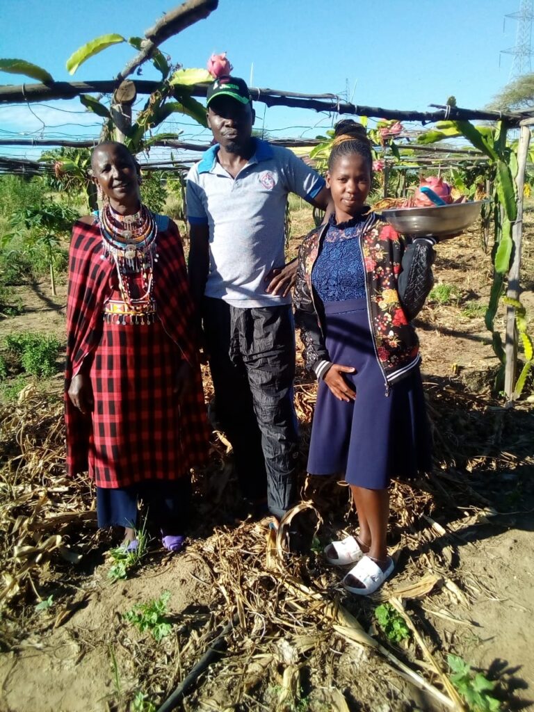 Maasai woman, man in grey shirt and Maasai young lady in dragon fruit farm